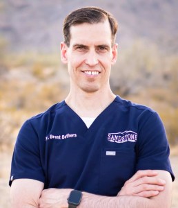 Dr. Bethers  smiling while posing in the desert
